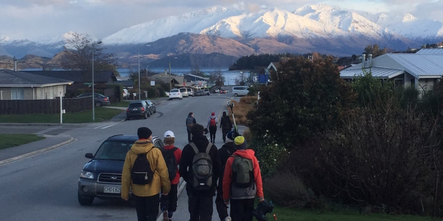 group of friends walking home with mountains in the background 