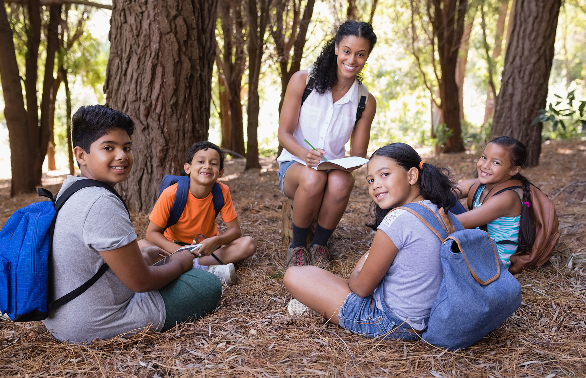 adventure camp tutor working outside with kids