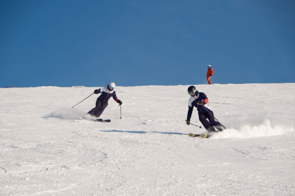 Isabella skiing with a fellow instructor