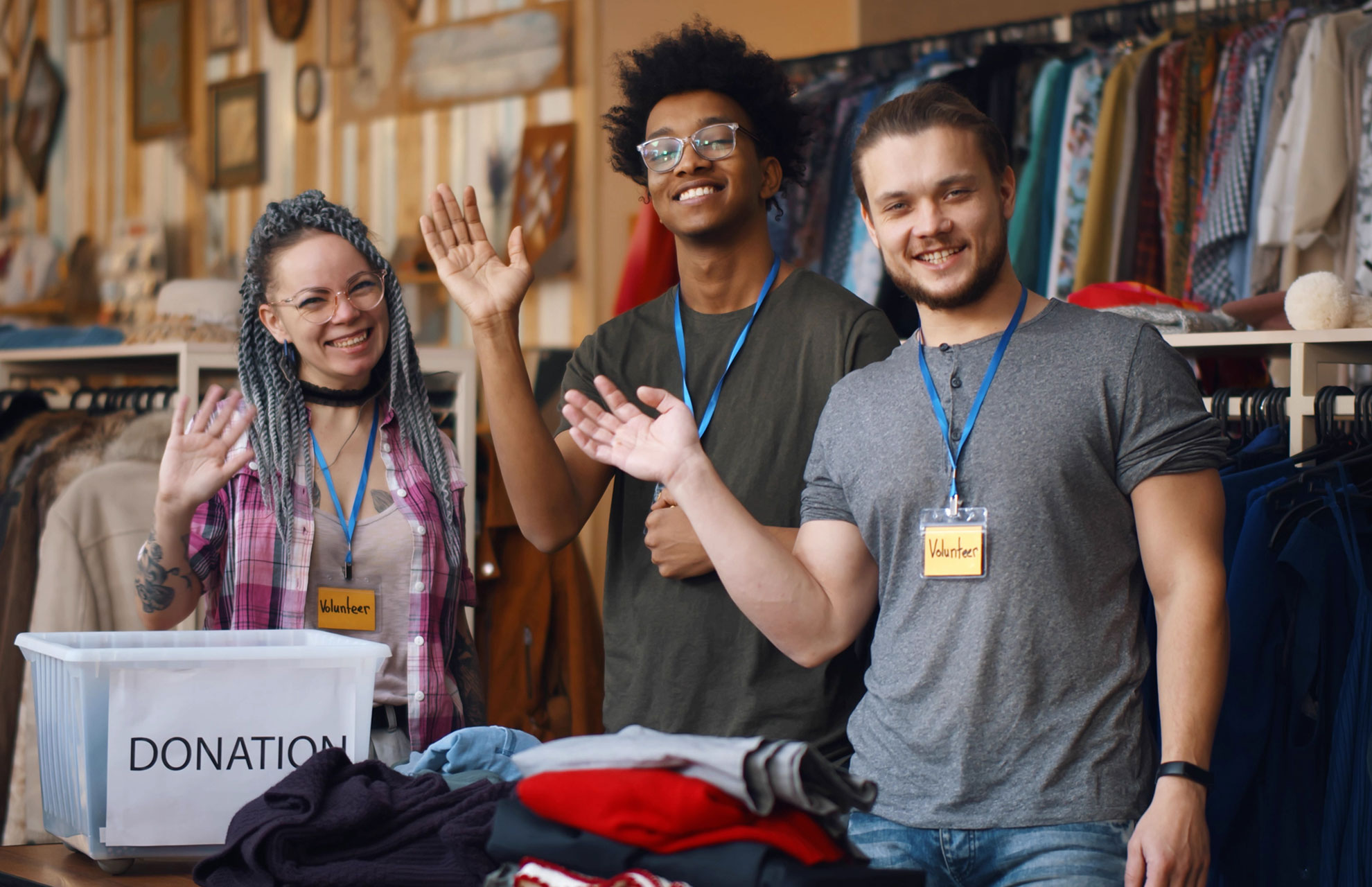 three volunteers at a charity shop